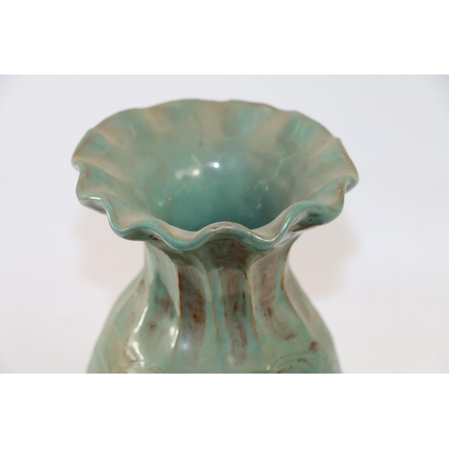 281 - Studio Pottery vase with flared rim and wave form decoration in blue/green glaze, 25cm high.