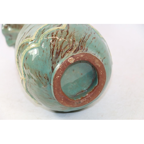 281 - Studio Pottery vase with flared rim and wave form decoration in blue/green glaze, 25cm high.