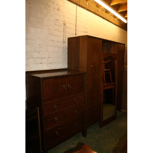 652 - Two piece oak bedroom suite comprising a wardrobe with central mirror, 183cm high and a chest of dra... 