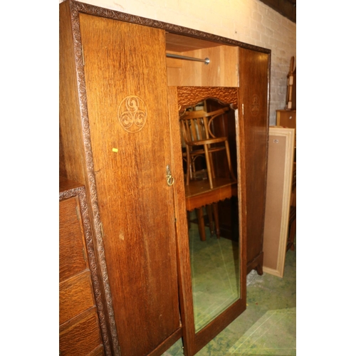 652 - Two piece oak bedroom suite comprising a wardrobe with central mirror, 183cm high and a chest of dra... 