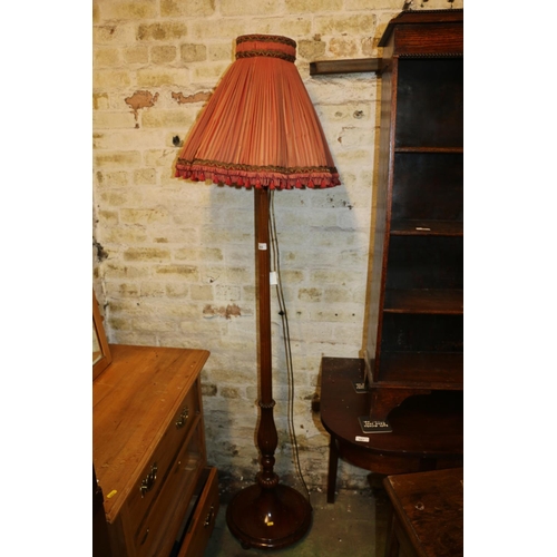 665 - Mahogany standard floor lamp of fluted column design on circular base, with shade, 187cm high.