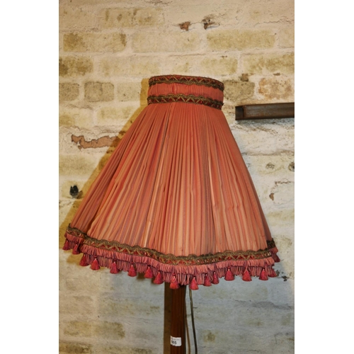 665 - Mahogany standard floor lamp of fluted column design on circular base, with shade, 187cm high.