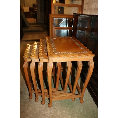 671 - Nest of four South East Asian tables with carved leaf decoration, raised on cabriole legs.