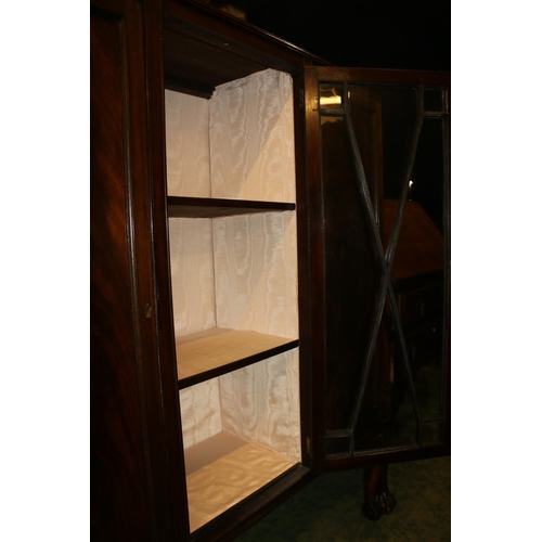 687 - Two door mahogany display cabinet, with central astragal glazed section, raised on cabriole legs ter... 