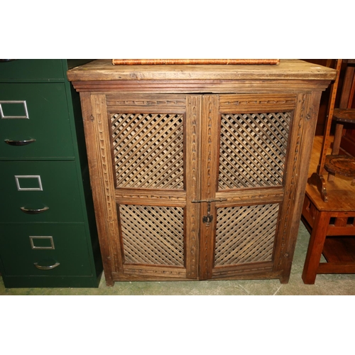 699 - Spanish softwood side cabinet with fretwork doors, 102cm high.