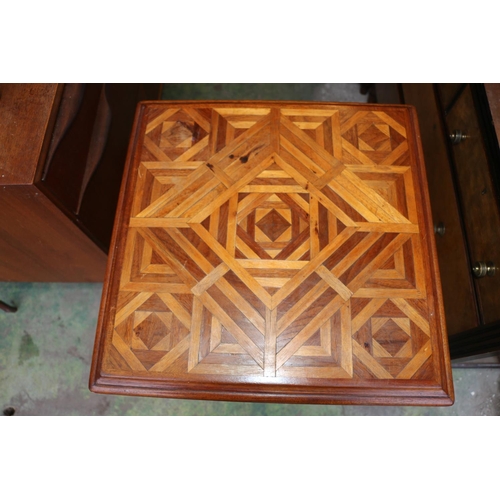 707 - Inlaid marquetry two-tier occasional table decorated in geometric design, 72cm high.