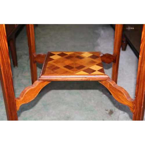 707 - Inlaid marquetry two-tier occasional table decorated in geometric design, 72cm high.