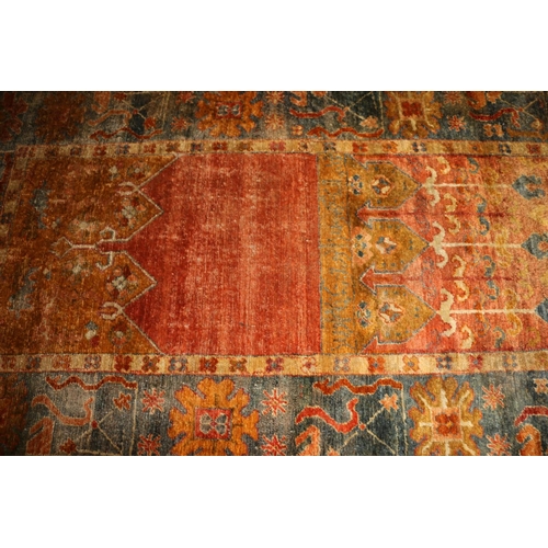 713 - Caucasian wall rug, rust red ground with geometric borders, 200cm x 140cm.