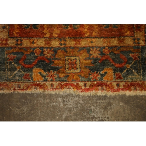 713 - Caucasian wall rug, rust red ground with geometric borders, 200cm x 140cm.