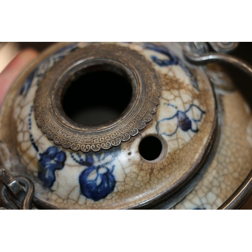 246 - Oriental blue and white pottery pot with metal handle and metal mounts in the form of hanging bats, ... 