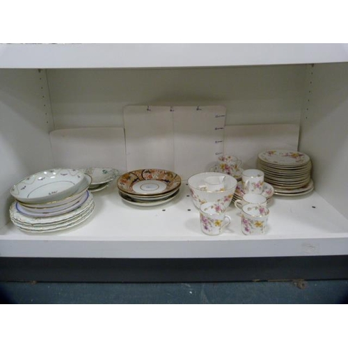 101 - Victorian plates, serving dishes, antique floral decorated part tea set etc (one shelf).