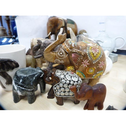 11 - Collection of animal ornaments, mainly elephants, to include ceramic, soapstone and wooden examples ... 