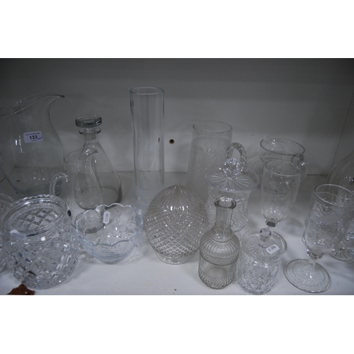 133 - Glassware to include jugs, kitchenalia, crystal bowl, crystal glasses, etched vases etc (one shelf).