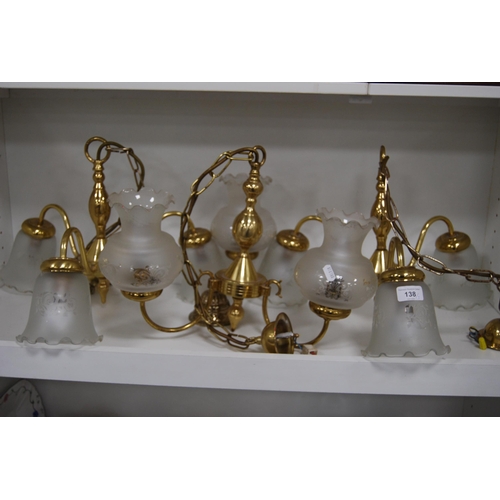 138 - Three modern gilt ceiling lights with glass shades.