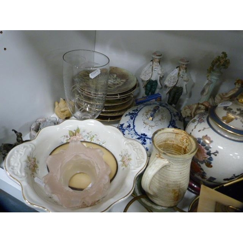 147 - Collector's plates, modern figures, vase, table lamp, modern mantel clock, tray etc (one shelf).