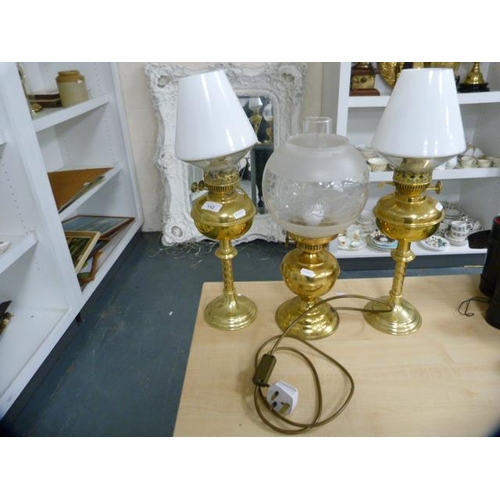 152 - Pair of brass oil lamps with later opaque glass shades and another later oil lamp.  (3)