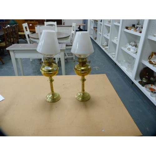 152 - Pair of brass oil lamps with later opaque glass shades and another later oil lamp.  (3)