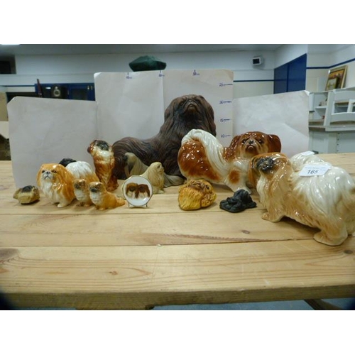 165 - Group of ceramic and resin spaniel figures to include examples by Beswick.