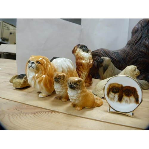 165 - Group of ceramic and resin spaniel figures to include examples by Beswick.