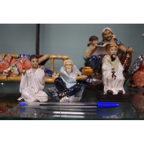 188 - Group of modern Oriental clay figures to include a warrior, sage, Geisha, and other groups.