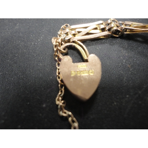 254 - 9ct gold padlock on chain.