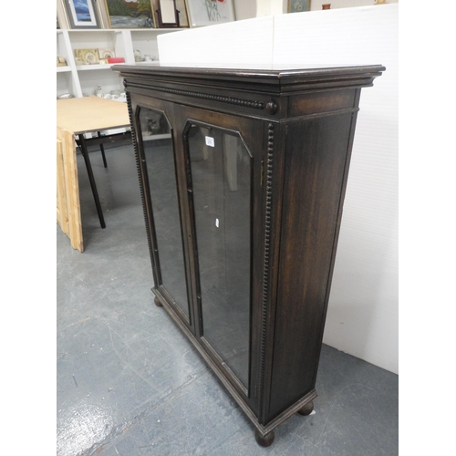 275 - Oak glazed two-door bookcase.