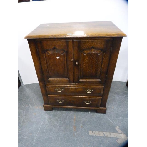 306 - Oak television cabinet with two doors above two drawers.