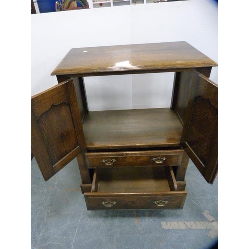 306 - Oak television cabinet with two doors above two drawers.