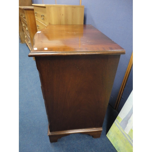 329 - Reproduction mahogany serpentine chest of drawers.