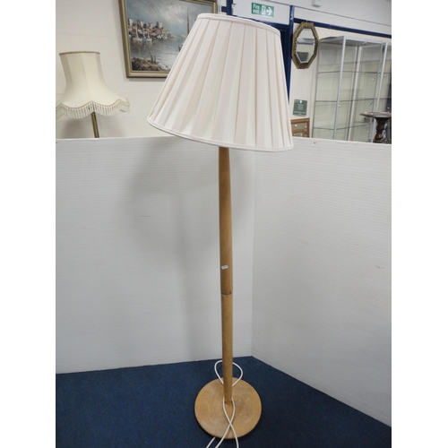 332 - Gilt metal floor lamp and shade, on animal paw feet.