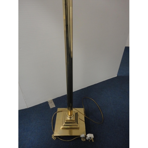 332 - Gilt metal floor lamp and shade, on animal paw feet.