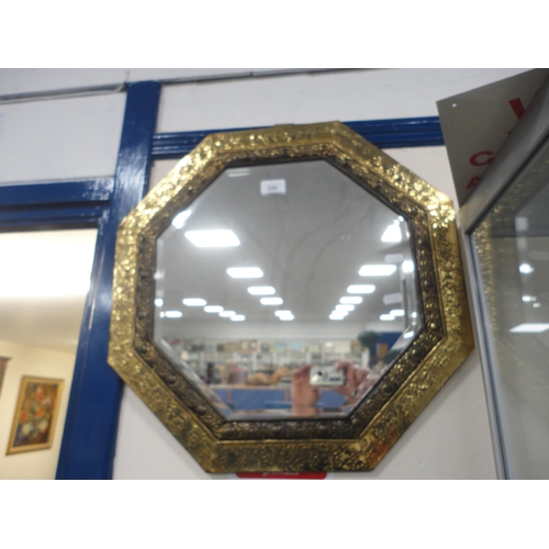 340 - Brass hammered octagonal wall mirror.