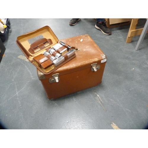 63 - Carry case and a gent's vintage cased toilet set.