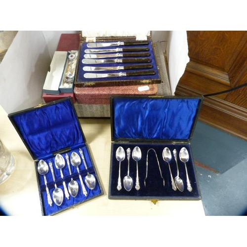 69 - Collection of boxed cutlery to include a set of six plated Apostle spoons, teaspoons and tongs, butt... 