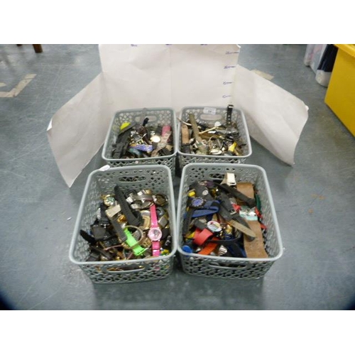 84 - Four tubs containing modern watch parts, cases, straps, movements etc.