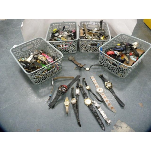 84 - Four tubs containing modern watch parts, cases, straps, movements etc.