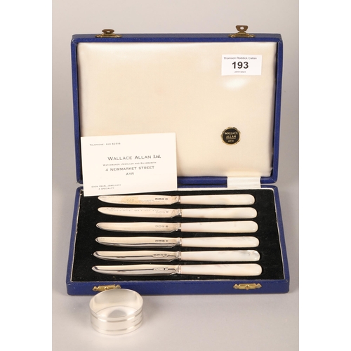 193 - Six silver and mother of pearl butter knives in case with silver napkin ring