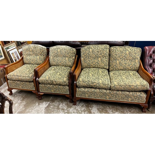 612 - Mahogany three piece bergere suite comprising of two seater settee and two single chairs. and a roll... 