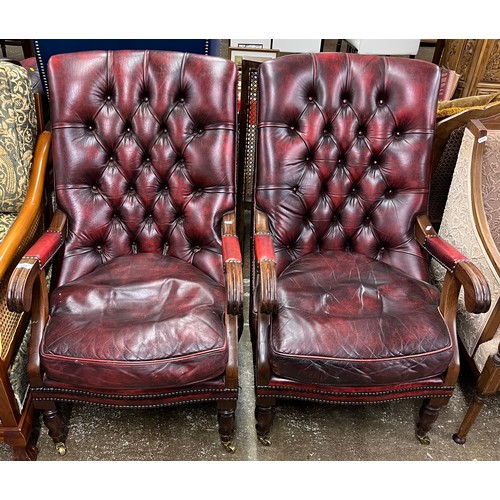 613 - Pair of leather button back armchairs.