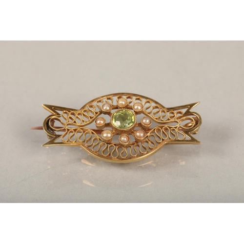 105 - Yellow metal brooch with central peridot & seed pearlsweight 3.9 grams