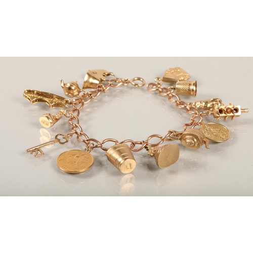 74 - 9 ct gold Charm bracelet with various charms to include gold half sovereign .38 grams