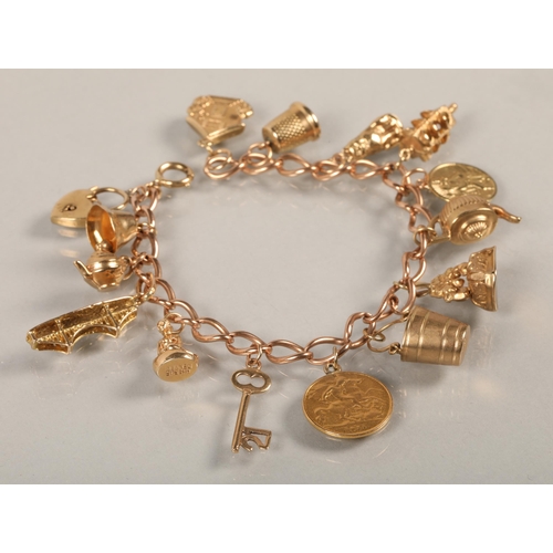 74 - 9 ct gold Charm bracelet with various charms to include gold half sovereign .38 grams