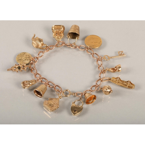 74 - 9 ct gold Charm bracelet with various charms to include gold half sovereign .38 grams