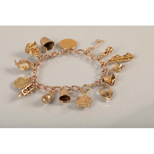 74 - 9 ct gold Charm bracelet with various charms to include gold half sovereign .38 grams