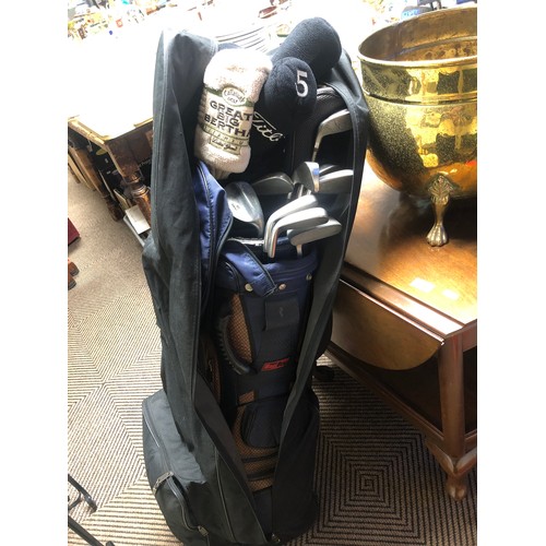 534 - Golf clubs, mostly Titleist, in golf bag (travel bag included)