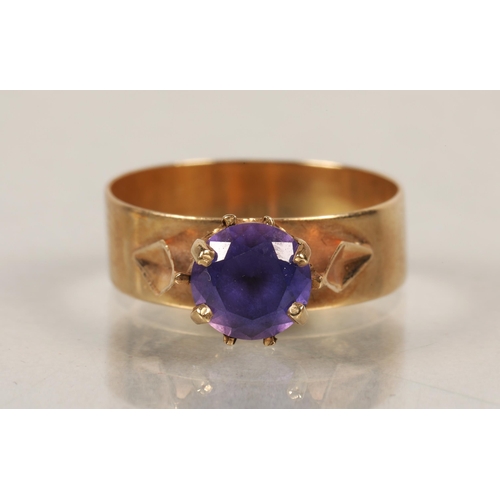 144 - 9ct gold dress ring with purple stone