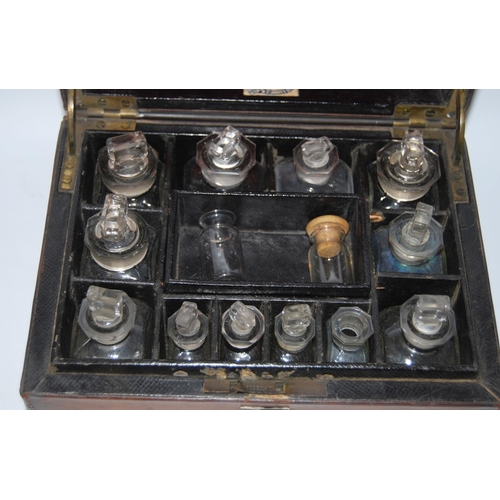 297 - Victorian tooled portable chemist's box containing glass bottles within a fitted interior, bearing a... 