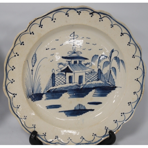 216 - Pair of late 18th century creamware blue and white plates, 24.5cm diameter.  (2)