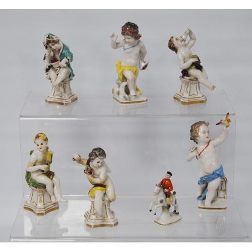 218 - Pair of 19th century Naples porcelain figures modelled as scantily-clad putti with a bird and dog, 1... 