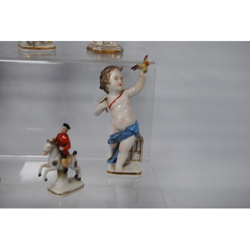 218 - Pair of 19th century Naples porcelain figures modelled as scantily-clad putti with a bird and dog, 1... 